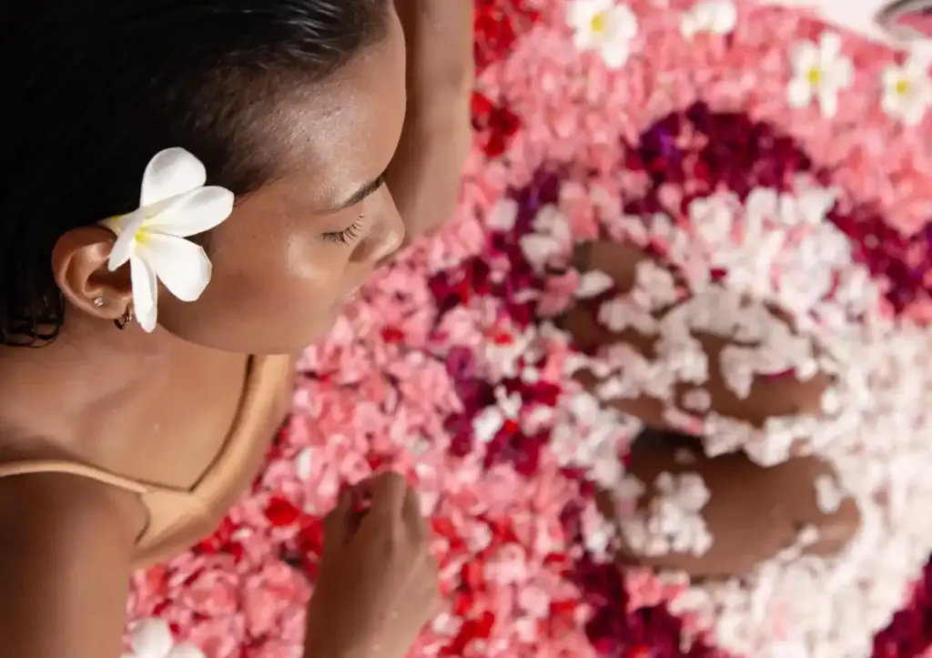 Woman relaxing in a luxury Balinese flower bath at Akoya Spa Ubud Bali