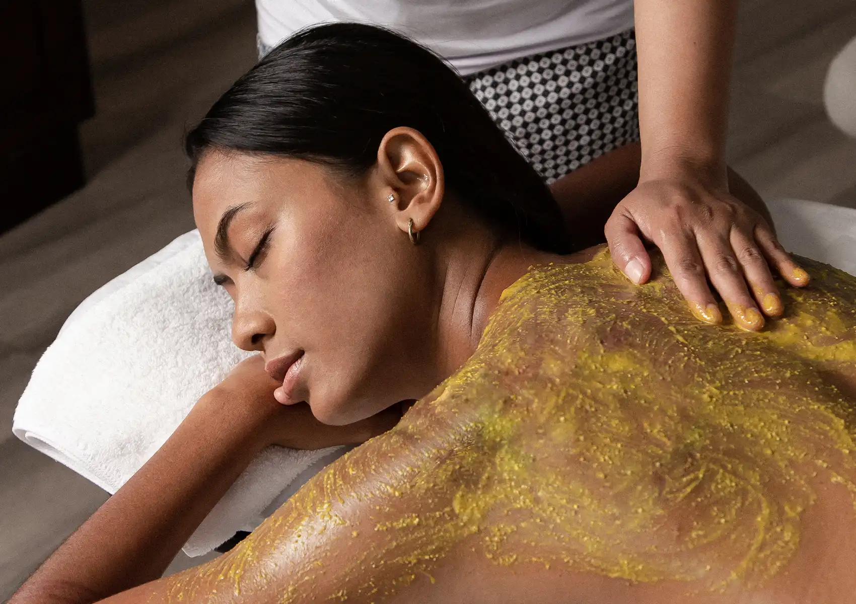 Traditional Balinese body scrub treatment at Akoya Spa Ubud Bali for deep relaxation and better sleep