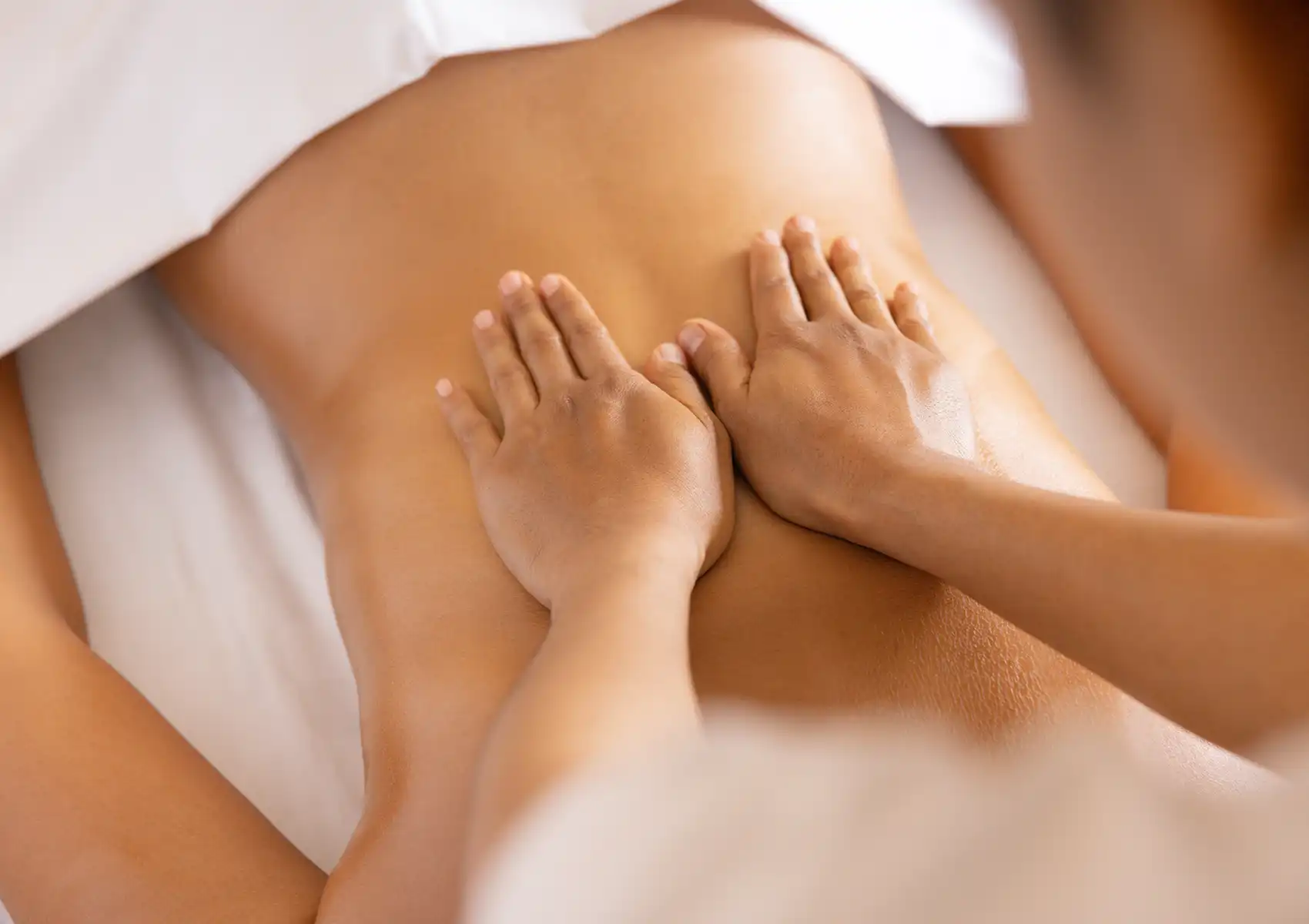 A therapist applying a relaxing back massage during a wellness session at the best spa in Ubud.